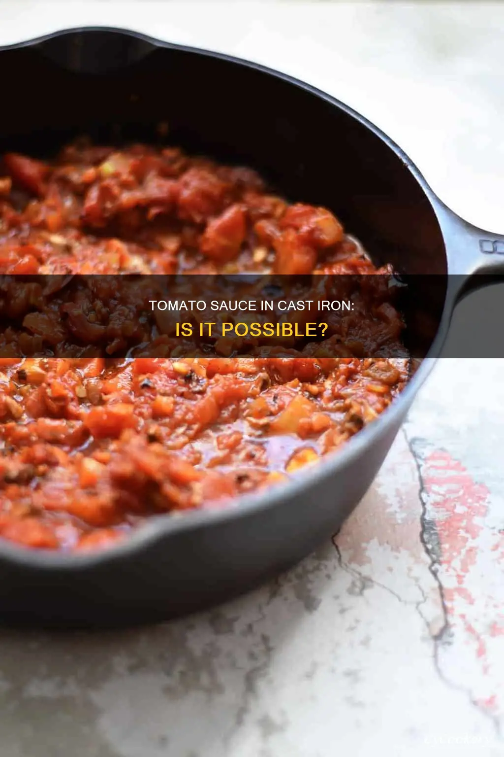can I cook tomato sauce in a cast iron pan