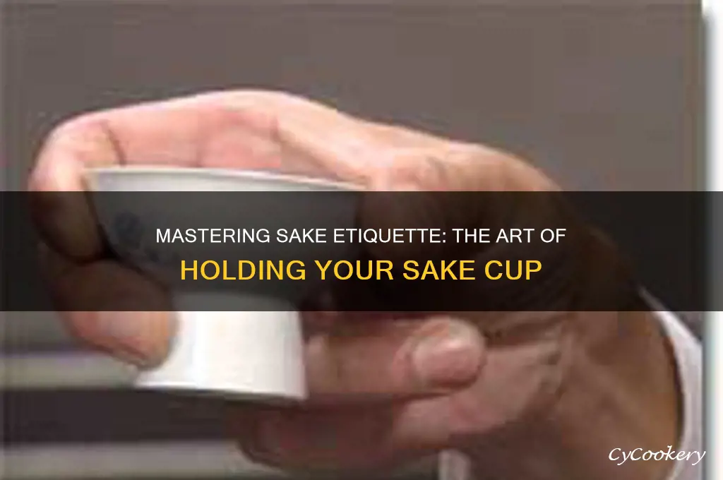 how to hold a sake cup