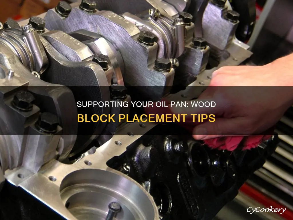 where to place wood block to support oil pan